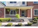 Inviting front porch with decorative plants, a stylish front door, and manicured landscaping, enhancing curb appeal at 11866 Weathered Edge Dr, Fishers, IN 46037