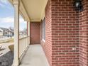Close-up view of a brick porch with white railings, showcasing the architectural details and curb appeal at 11866 Weathered Edge Dr, Fishers, IN 46037