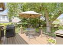 Inviting back deck featuring a patio table, chairs, and a grill perfect for outdoor relaxation at 14 Kessler Blvd W Dr, Indianapolis, IN 46208