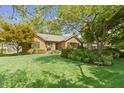 Charming home with a lush green lawn and beautiful landscaping enhancing its curb appeal at 14 Kessler Blvd W Dr, Indianapolis, IN 46208