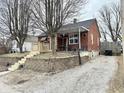 Brick home featuring a front porch and updated landscaping at 24 N Clay St, Mooresville, IN 46158