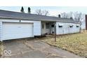 View of the front exterior showcasing the attached one-car garage and driveway at 2513 W 10Th St, Muncie, IN 47302