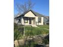 Classic single-story house featuring a covered front porch and tidy front yard at 2526 Eastern Ave, Indianapolis, IN 46218