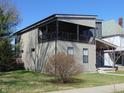 Stylish exterior showcasing vertical siding, covered balcony, and well-maintained lawn on a sunny day at 2528 Carrollton Ave, Indianapolis, IN 46205