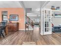 Inviting entryway featuring wood floors, a staircase, and a view into a bright, open-concept living space at 2808 Twinleaf Dr, Plainfield, IN 46168