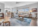 Bright living room with modern decor, comfortable seating, large windows, and an open layout to the kitchen at 2808 Twinleaf Dr, Plainfield, IN 46168