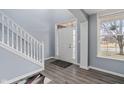 Bright foyer featuring wood floors, a staircase, and a window allowing ample natural light at 3322 Paisley Pointe, Whitestown, IN 46075