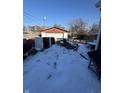 Snowy backyard featuring a detached garage and patio area, and barbeque at 3425 Forest Manor Ave, Indianapolis, IN 46218