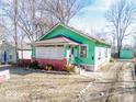 Inviting single Gathering home with green exterior, classic porch, and nice curb appeal, ready for its next chapter at 3455 Hillside Ave, Indianapolis, IN 46218