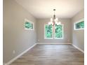 Bright dining area with hardwood floors and large windows offering a scenic view at 3604 Maple Ridge Dr, Columbus, IN 47201