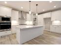 Bright kitchen with white cabinets, stainless steel appliances, granite countertops, and a large island at 3604 Maple Ridge Dr, Columbus, IN 47201