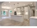 Open-concept kitchen with an island, stainless steel appliances, and hardwood floors at 3604 Maple Ridge Dr, Columbus, IN 47201