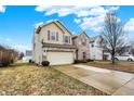 View of charming two-story home with a two-car garage and long driveway at 3844 Kilburn Ct, Indianapolis, IN 46228