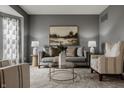 Cozy living room featuring neutral tones, stylish furniture, decorative lighting, and a serene ambiance at 3880 Heathfield Ct, Zionsville, IN 46077