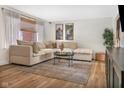 Bright living room featuring a plush sectional sofa, hardwood floors, and stylish decor at 424 Simmons St, Plainfield, IN 46168