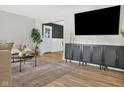Spacious living room with hardwood floors, stylish cabinet, and comfortable seating area at 424 Simmons St, Plainfield, IN 46168