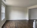 Spacious living room featuring hardwood floors and bright window with natural light at 457 Prince Dr, Greenwood, IN 46142