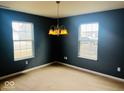 Formal dining room featuring neutral carpet, chandelier, and natural light, creating an elegant dining space at 476 Haywood Dr, Greenfield, IN 46140