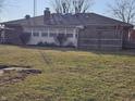 Spacious backyard featuring a partial fence for privacy and mature trees at 4921 Dancer Dr, Indianapolis, IN 46237