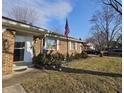 Brick ranch style home featuring manicured bushes and a sidewalk to the front door at 4921 Dancer Dr, Indianapolis, IN 46237