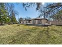 Inviting front yard showcases a well-maintained lawn and mature trees at 5451 Buttonwood Dr, Noblesville, IN 46062
