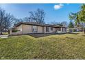 Lovely one-story home with mature landscaping, complemented by a lush green lawn at 5451 Buttonwood Dr, Noblesville, IN 46062
