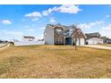 Charming house featuring brick and siding exterior, a three-car garage, and a well-maintained lawn at 61 Larimar Way, Whiteland, IN 46184
