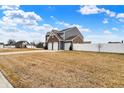 Attractive two-story home with brick accents, a three-car garage, and a partial view of the backyard at 61 Larimar Way, Whiteland, IN 46184