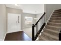Inviting foyer with a staircase, hardwood flooring, natural light, and an open view into the living space at 61 Larimar Way, Whiteland, IN 46184