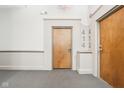 Hallway with unit numbers outside of doors on carpeted floor at 611 N Park Ave # 414, Indianapolis, IN 46204