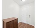Inviting entryway features wood-look flooring, a white front door, and a storage cabinet at 664 Beaverbrook Dr, Carmel, IN 46032
