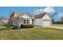 Lovely exterior view of home with well-maintained lawn and attached two-car garage at 664 Beaverbrook Dr, Carmel, IN 46032