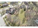 Aerial view of a residential neighborhood with mature trees, well-manicured lawns, and a house with a backyard at 7806 Ashtree Dr, Indianapolis, IN 46259