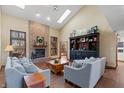 Cozy living room with a brick fireplace, high ceilings, hardwood floors, and comfortable seating arrangements at 7806 Ashtree Dr, Indianapolis, IN 46259