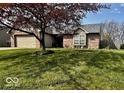 Charming brick single-story home with a well-maintained lawn, and attached two-car garage in a residential area at 8076 Captain Dr, Avon, IN 46123