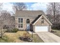 Charming two-story brick home featuring an attached garage and neat landscaping at 9046 Glass Chimney Ln, Fishers, IN 46037