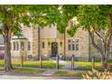 Beautiful stone home with well-maintained landscaping, offering a glimpse of classic elegance and charm at 906 Franklin St, Columbus, IN 47201