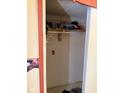 A small walk-in closet with shelving and a hanging rod, suitable for organizing clothes and storage at 911 W 3Rd St, Anderson, IN 46016