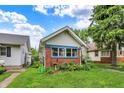 A well-kept home with brick detail, blue trim and a neatly manicured front yard at 960 Cameron St, Indianapolis, IN 46203
