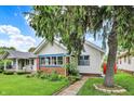 Inviting home with well-maintained lawn, brick foundation, and vibrant blue window trim at 960 Cameron St, Indianapolis, IN 46203
