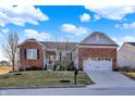 Inviting brick home with a well-manicured lawn and attached two-car garage, radiating curb appeal at 9695 Wandering Woods Ct, Fishers, IN 46037
