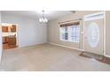 Bright living room with large windows, neutral carpet, and an adjacent view of the kitchen at 11453 Scheel Ln, Carmel, IN 46032