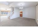 Spacious living room with a staircase, neutral carpet, and an adjacent view of the kitchen at 11453 Scheel Ln, Carmel, IN 46032