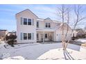 Attractive two-story home with a two-car garage and snow covered front yard at 11835 Bengals Dr, Fishers, IN 46037