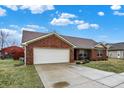 Brick ranch with a two-car garage and concrete driveway at 13 Watson Dr, Trafalgar, IN 46181