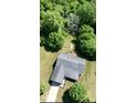 Aerial view of a home nestled in a lush, green wooded lot with mature trees at 130 Hanover Dr, Morristown, IN 46161