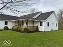 This home has a large front porch with lots of curb appeal on a manicured lawn at 130 Hanover Dr, Morristown, IN 46161