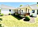Charming single-story home with a welcoming front porch and well-maintained landscaping at 130 Hanover Dr, Morristown, IN 46161