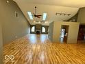 Spacious living room with vaulted ceilings, skylights, and beautiful laminate flooring at 130 Hanover Dr, Morristown, IN 46161