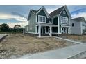 Side view of craftsman-style home showing yard with partial landscaping at 13610 Grand Abbey Way, Fishers, IN 46037